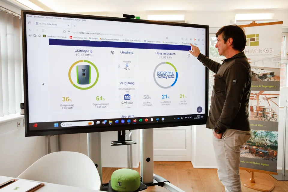 A person operating a large digital display in the Main Meeting Room.